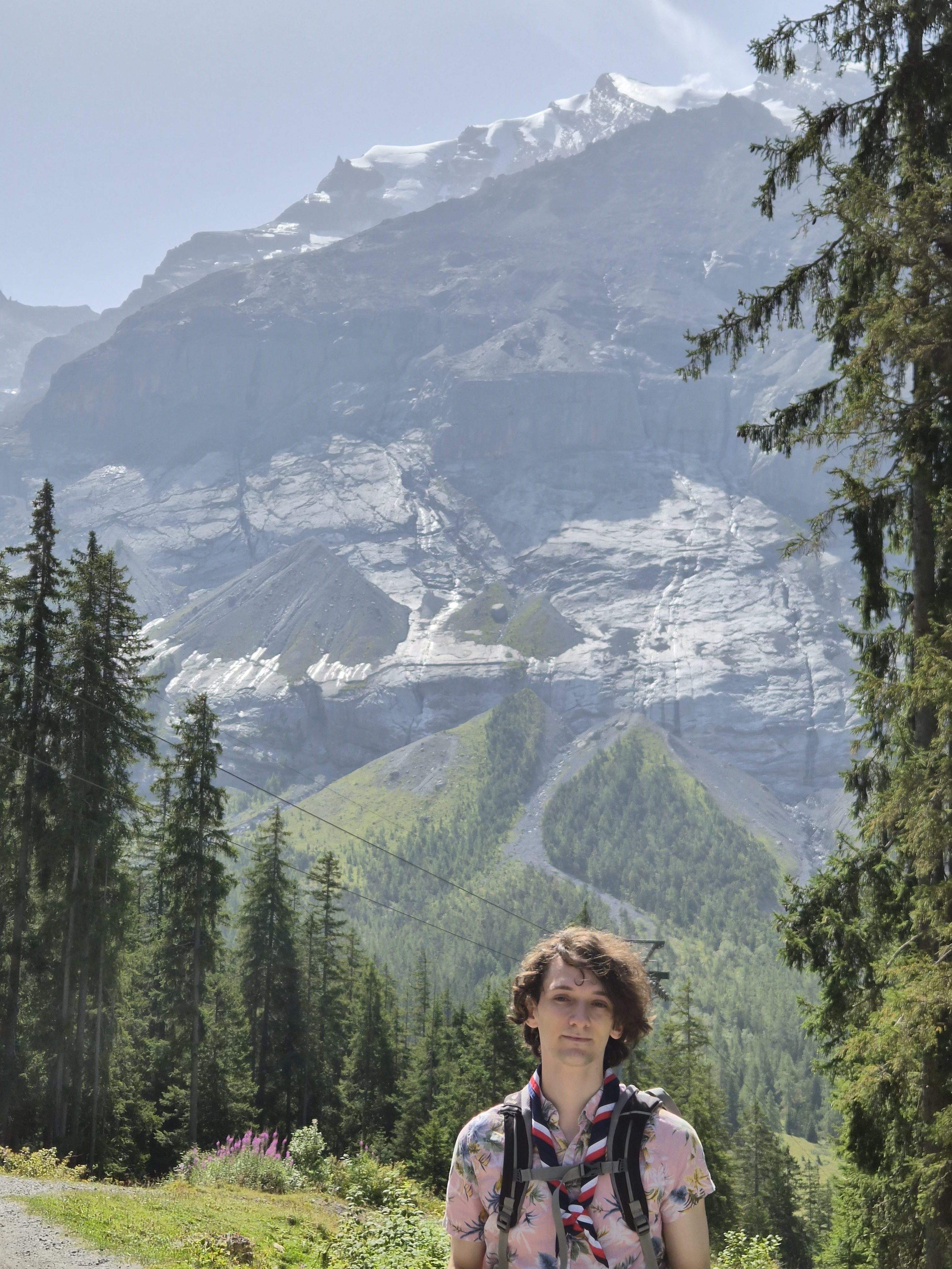 Blyth sitting in front of a mountain landscape